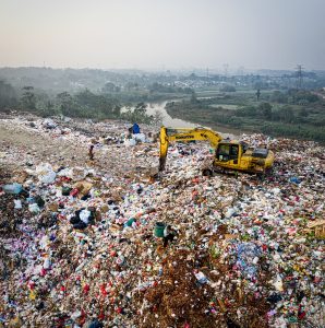  A Komatsu vehicle equipped with hydraulic cylinders operating in a landfill. The hydraulic cylinders enable the vehicle to compact and level waste materials, optimizing landfill capacity and promoting efficient waste management practices.