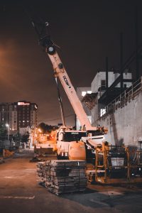A crane with a hydraulic cylinder in action, lifting heavy loads with precision and control, exemplifying the power and versatility of hydraulic technology in material handling operations.